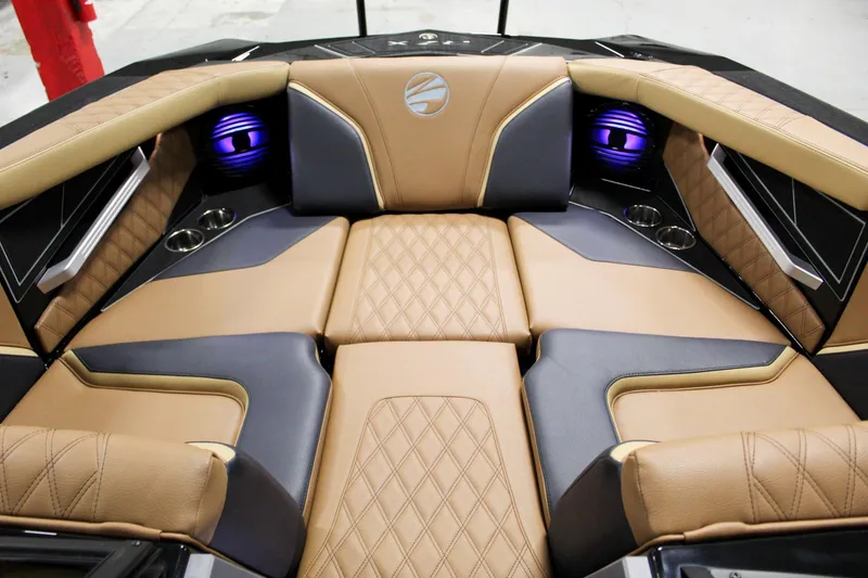 Slide: The Image of 2025 Tigé 22RZX boat interior with luxurious tan and black seating, featuring purple speakers. - 8