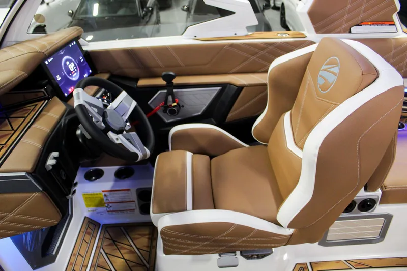 Slide: The Image of 2025 Tigé Ultré 25ZX boat interior with luxurious captain's seat and advanced dashboard controls. - 10