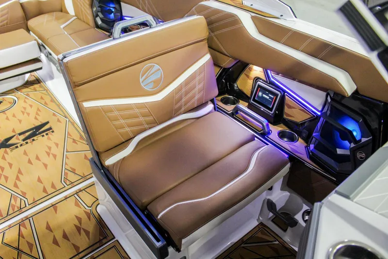 Slide: The Image of 2025 Tigé Ultré 25ZX boat interior with luxurious brown seating and modern controls. - 11