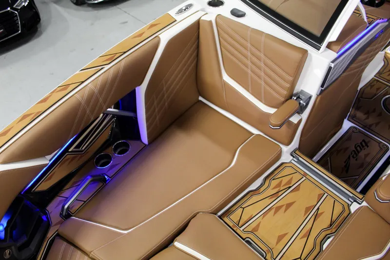 Slide: The Image of Luxurious interior of 2025 Tigé Ultré 25ZX boat with tan leather seating and blue LED lighting. - 14