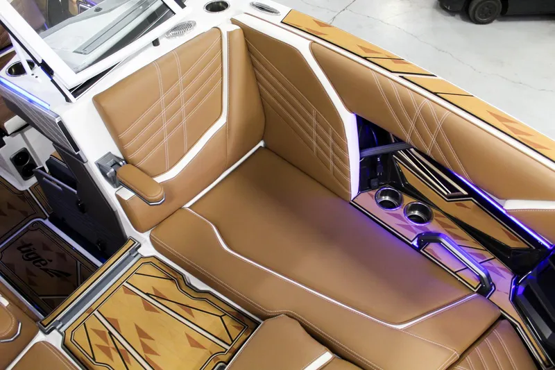 Slide: The Image of 2025 Tigé Ultré 25ZX boat interior with tan leather seats and modern design accents. - 15