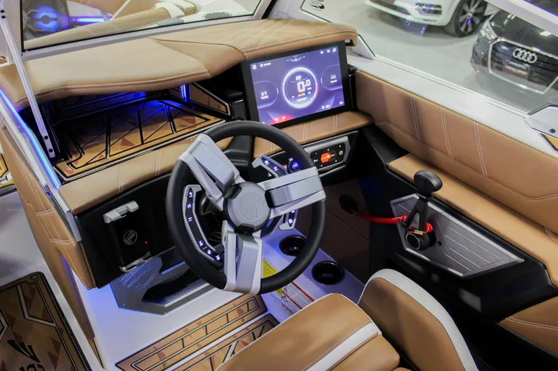 Slide: The Image of 2025 Tigé Ultré 25ZX boat interior with modern dashboard and steering wheel. - 17