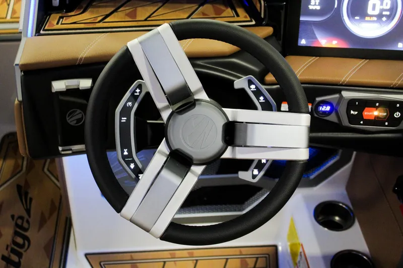 Slide: The Image of Steering wheel of 2025 Tigé Ultré 25ZX boat, featuring modern controls and dashboard. - 18