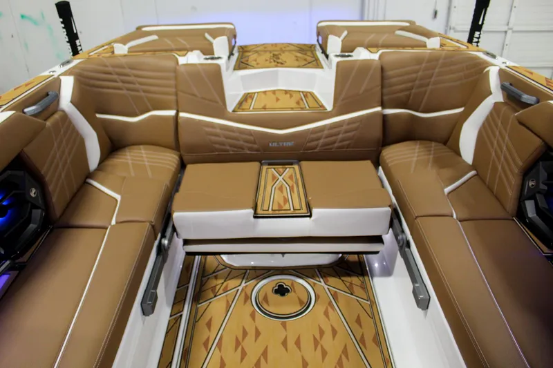 Slide: The Image of 2025 Tigé Ultré 25ZX boat interior with luxurious brown seating and stylish flooring. - 26