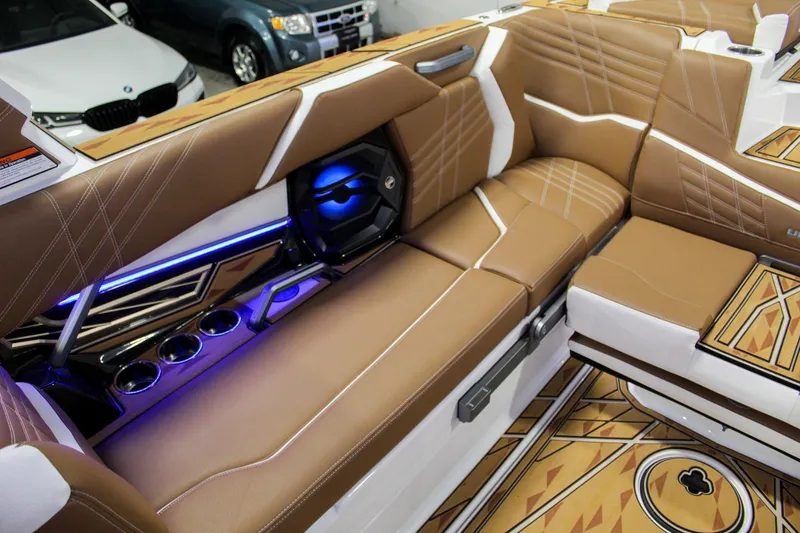 Slide: The Image of Luxurious interior of 2025 Tigé Ultré 25ZX boat with brown leather seating and LED lighting. - 28