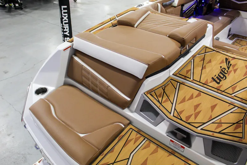 Slide: The Image of 2025 Tigé Ultré 25ZX boat interior with brown leather seats and geometric flooring. - 30