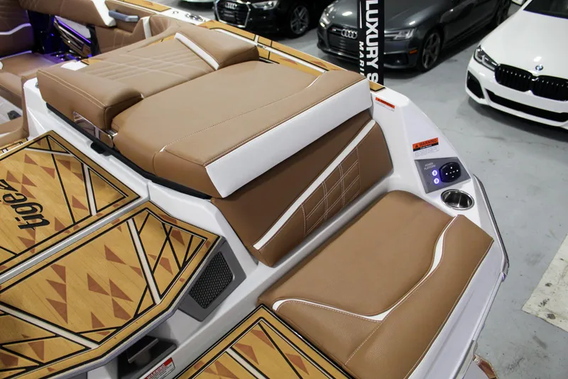 Slide: The Image of 2025 Tigé Ultré 25ZX boat interior with tan seating and geometric design. - 31