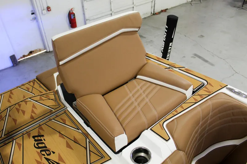 Slide: The Image of 2025 Tigé Ultré 25ZX boat interior with tan leather seating and geometric design. - 33