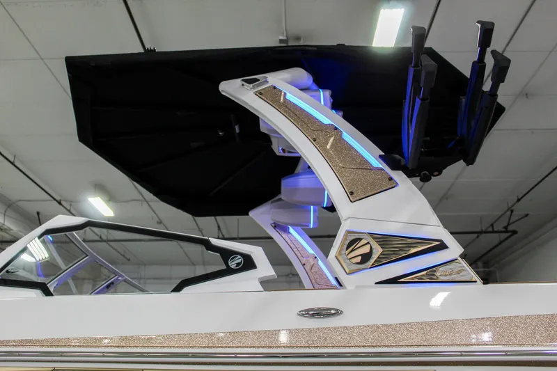 Slide: The Image of 2025 Tigé Ultré 25ZX boat with illuminated tower and sleek design in indoor setting. - 37