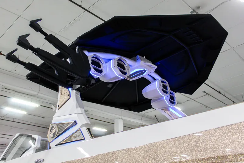 Slide: The Image of 2025 Tigé Ultré 25ZX boat with advanced speakers and canopy, indoor display. - 38