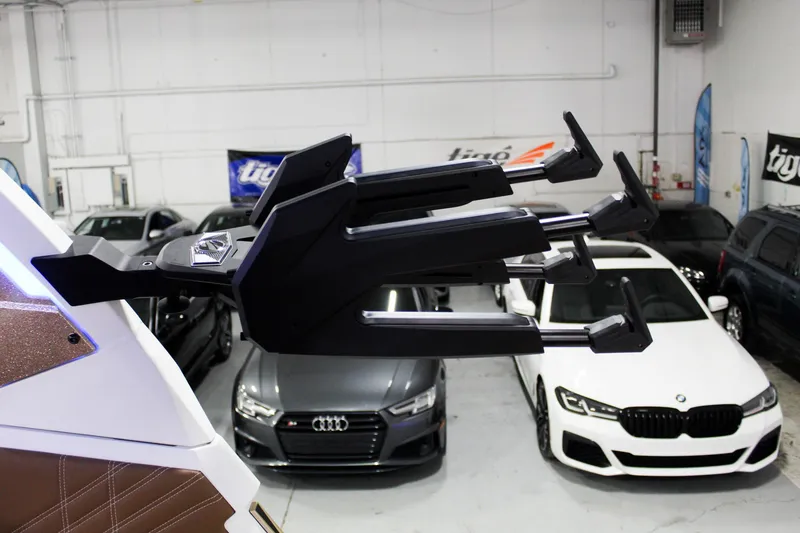 Slide: The Image of 2025 Tigé Ultré 25ZX boat accessory in showroom with luxury cars in background. - 39