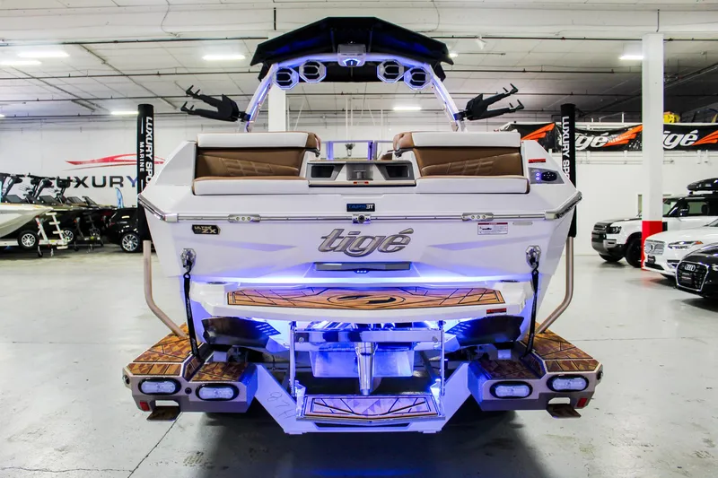 Slide: The Image of 2025 Tigé Ultré 25ZX boat with illuminated deck in showroom. - 4