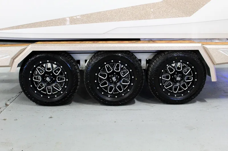 Slide: The Image of Triple axle trailer with stylish black wheels for 2025 Tigé Ultré 25ZX boat. - 42