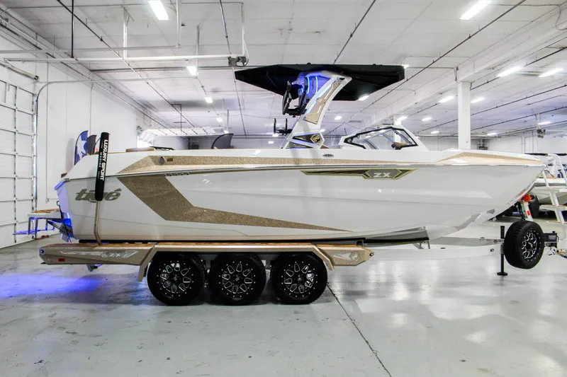 Slide: The Image of 2025 Tigé Ultré 25ZX boat on trailer in a showroom setting. - 6
