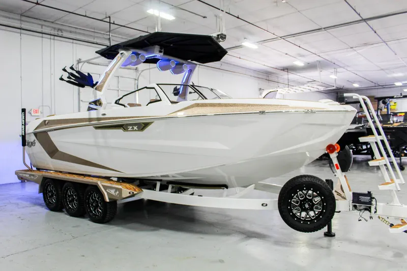 Slide: The Image of 2025 Tigé Ultré 25ZX boat on trailer in indoor showroom. - 7