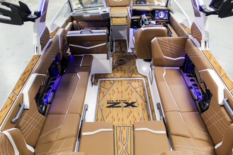 Slide: The Image of 2025 Tigé Ultré 25ZX boat interior with luxurious brown seating and modern dashboard. - 8