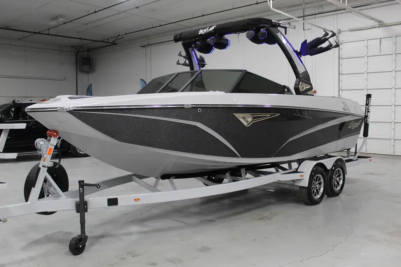 Slide: The Image of 2025 Tigé Z3 boat on trailer in indoor showroom. - 1