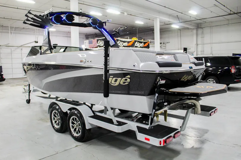 Slide: The Image of 2025 Tigé Z3 boat on trailer in indoor showroom, featuring sleek design and modern features. - 2