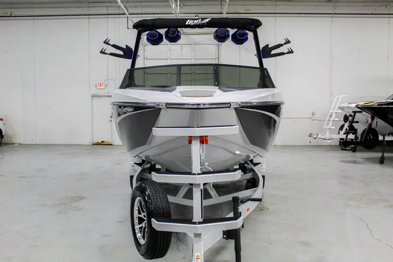 Slide: The Image of 2025 Tigé Z3 boat in showroom, front view, sleek design, on trailer. - 3