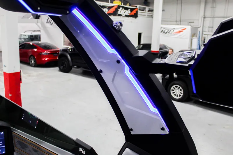 Slide: The Image of 2025 Tigé Z3 boat interior with illuminated blue LED accents in a showroom. - 31