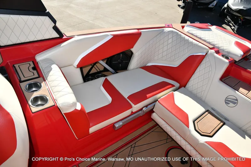 Slide: The Image of 2022 Tigé 24RZX boat interior with red and white seating and cup holders. - 15