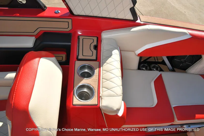 Slide: The Image of 2022 Tigé 24RZX boat interior with red and beige seating and cup holders. - 16