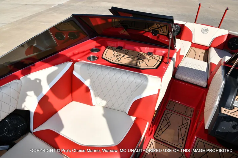 Slide: The Image of 2022 Tigé 24RZX boat interior with red and white seating, cup holders, and stylish flooring. - 20