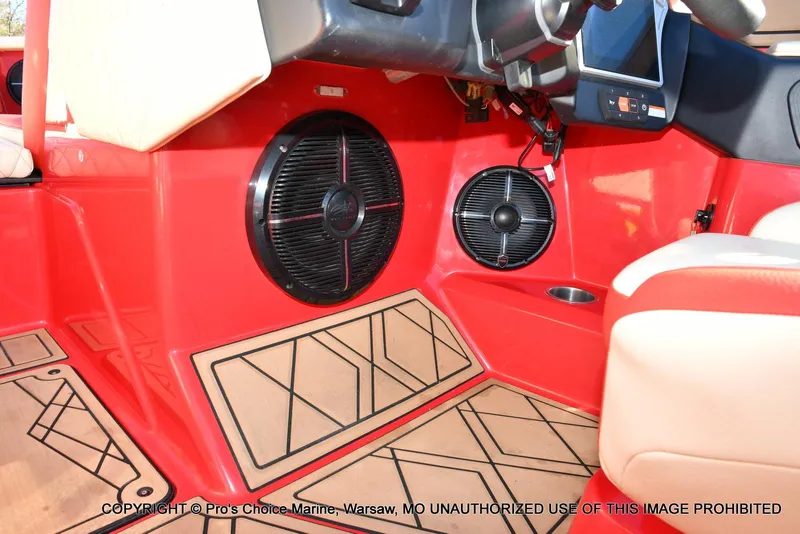 Slide: The Image of Interior of 2022 Tigé 24RZX boat with red paneling and speaker system. - 22