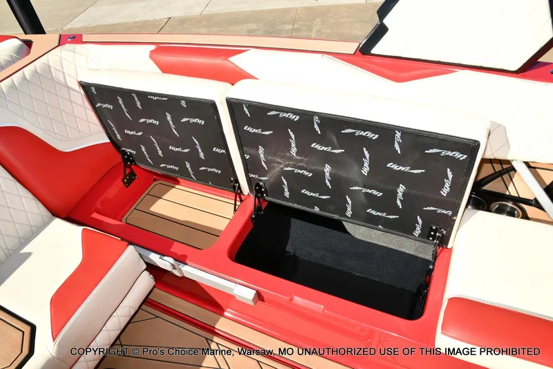 Slide: The Image of 2022 Tigé 24RZX boat interior with open storage compartments, red and white seating. - 31