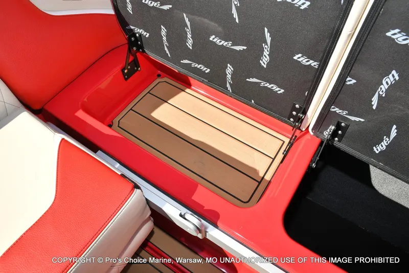 Slide: The Image of 2022 Tigé 24RZX boat interior with red and white seating and wood-patterned flooring. - 33