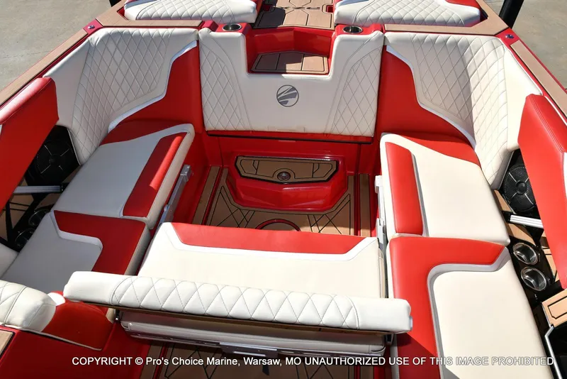 Slide: The Image of 2022 Tigé 24RZX boat interior with red and white seating, featuring diamond stitching. - 34