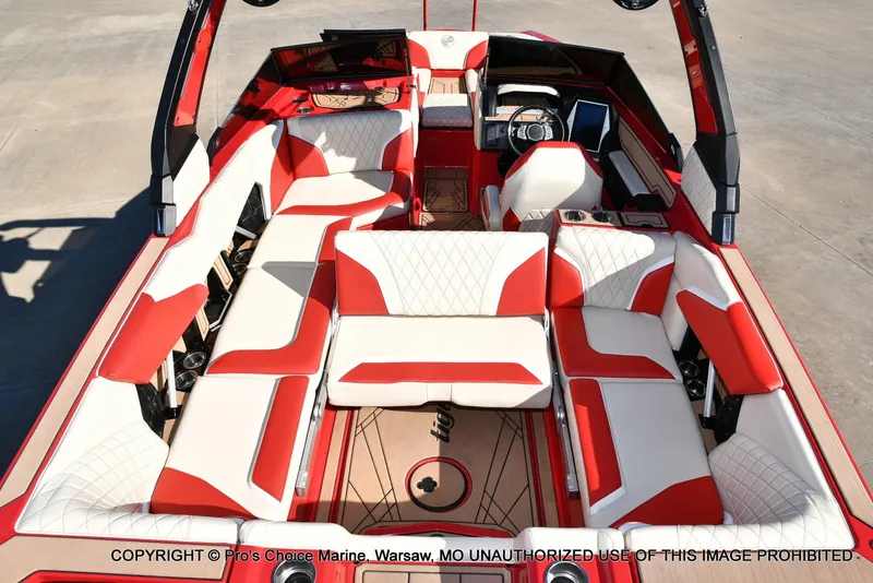 Slide: The Image of 2022 Tigé 24RZX boat interior with red and white seating, modern dashboard, and spacious layout. - 35