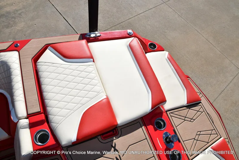 Slide: The Image of 2022 Tigé 24RZX boat interior with red and white seating and cup holders. - 37