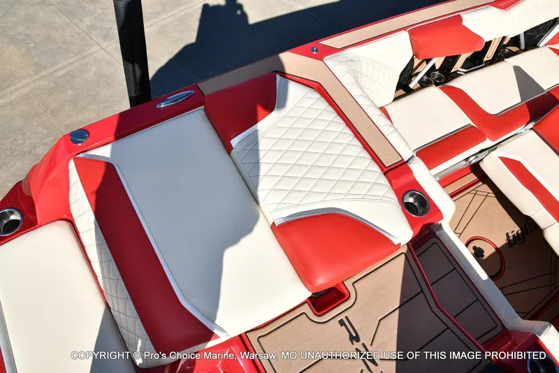 Slide: The Image of 2022 Tigé 24RZX boat interior with red and white seating, cup holders, and stylish design. - 38