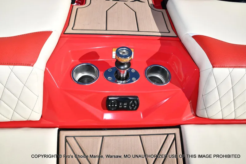 Slide: The Image of 2022 Tigé 24RZX boat interior with red and white seating, cup holders, and control panel. - 41
