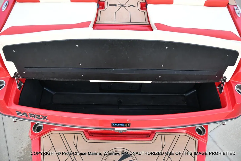 Slide: The Image of 2022 Tigé 24RZX boat with open rear storage compartment, red and white seating. - 43