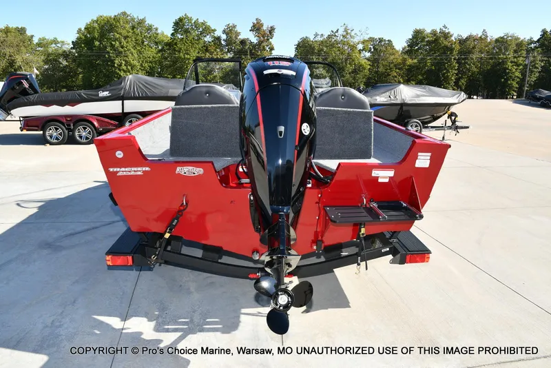 Slide: The Image of 2025 Tracker Pro Guide V-175 Combo boat, rear view, red exterior, parked outdoors. - 12