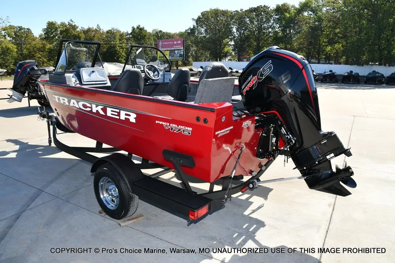 Slide: The Image of 2025 Tracker Pro Guide V-175 Combo boat on trailer, red exterior, outdoor setting. - 13