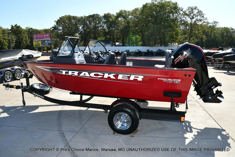 Slide: The Image of 2025 Tracker Pro Guide V-175 Combo boat on trailer, red exterior, parked outdoors. - 14