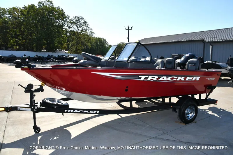 Slide: The Image of 2025 Tracker Pro Guide V-175 Combo boat in red on a trailer, outdoor setting. - 15