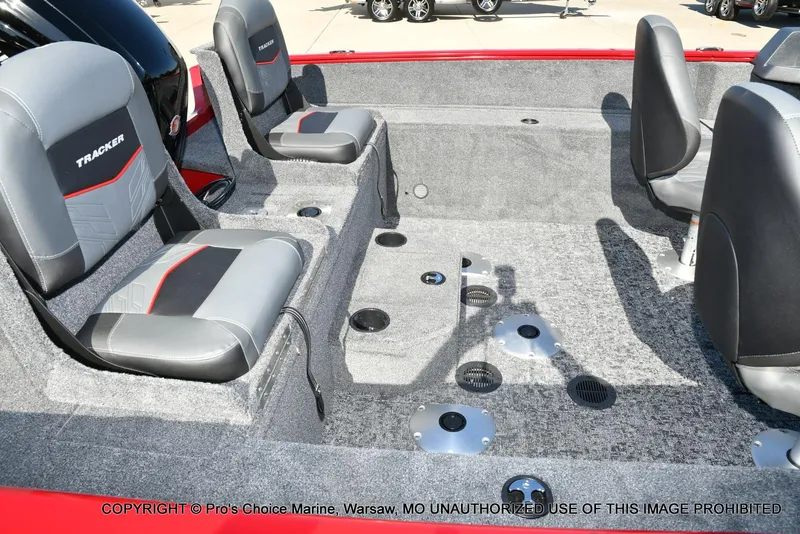 Slide: The Image of 2025 Tracker Pro Guide V-175 Combo boat interior with gray seating and carpeted flooring. - 22