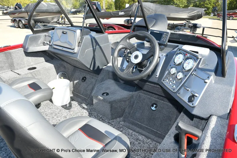 Slide: The Image of 2025 Tracker Pro Guide V-175 Combo boat interior with steering wheel and dashboard controls. - 23