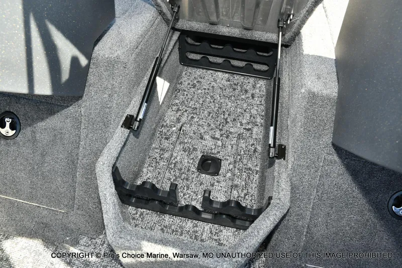 Slide: The Image of 2025 Tracker Pro Guide V-175 Combo interior storage compartment with carpeted finish and hydraulic supports. - 47