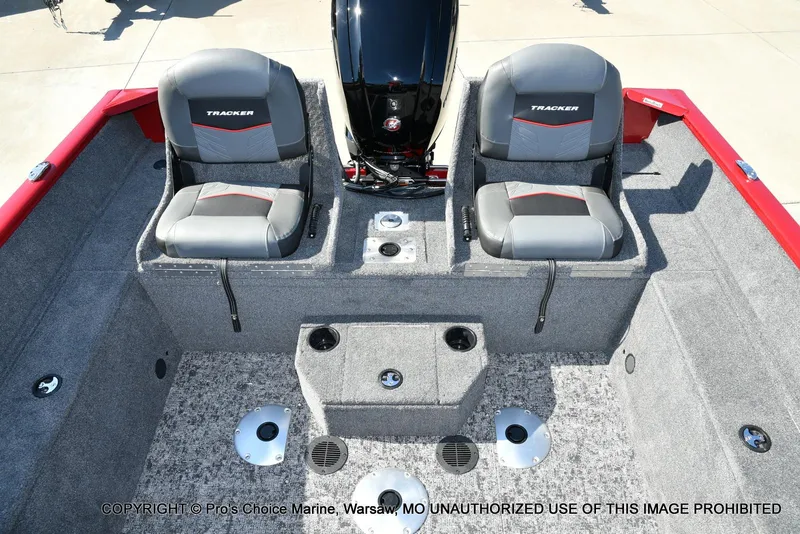 Slide: The Image of 2025 Tracker Pro Guide V-175 Combo boat interior with two gray seats and red accents. - 7