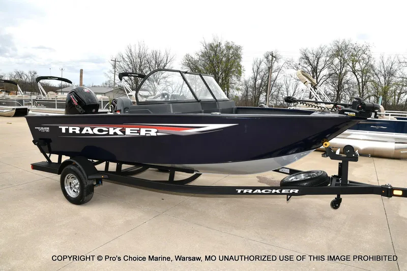Slide: The Image of 2025 Tracker Pro Guide V-175 Walk-Thru boat on trailer, parked outdoors. - 9