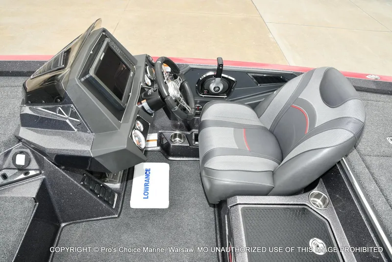 Slide: The Image of 2018 Ranger Z520L CUP boat cockpit with steering wheel, control panel, and cushioned seat. - 44
