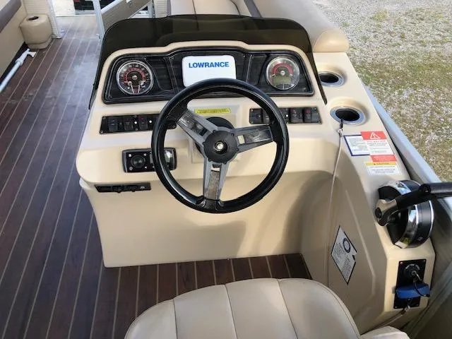 Slide: The Image of 2020 Sweetwater 2286 boat dashboard with steering wheel and Lowrance navigation system. - 10