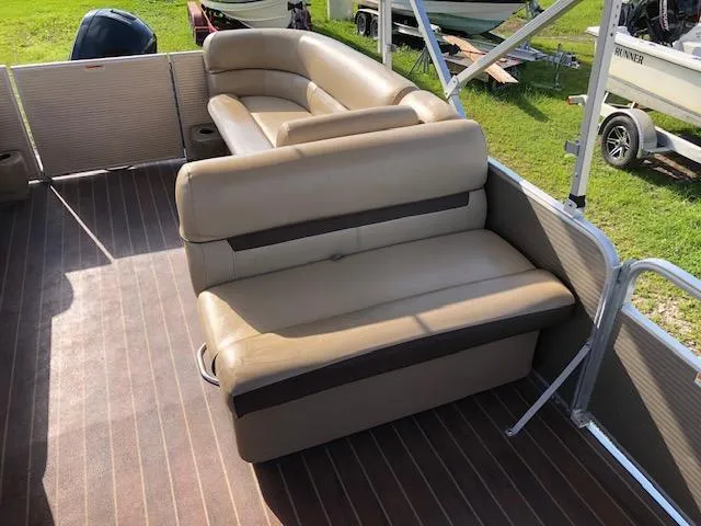 Slide: The Image of 2020 Sweetwater 2286 pontoon boat with beige seating and brown flooring. - 14