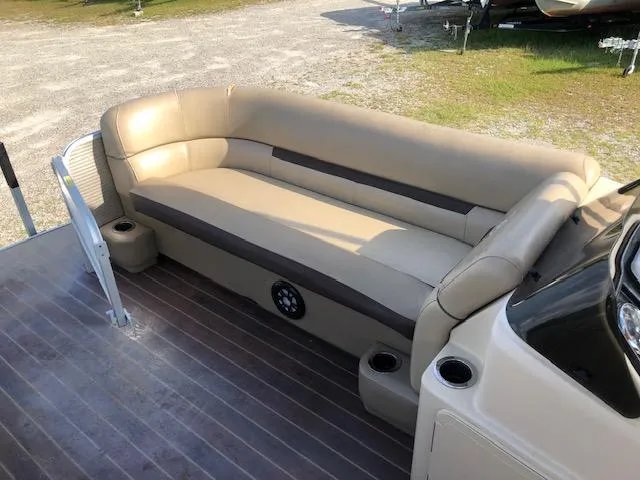 Slide: The Image of 2020 Sweetwater 2286 boat interior with beige seating and cup holders. - 16