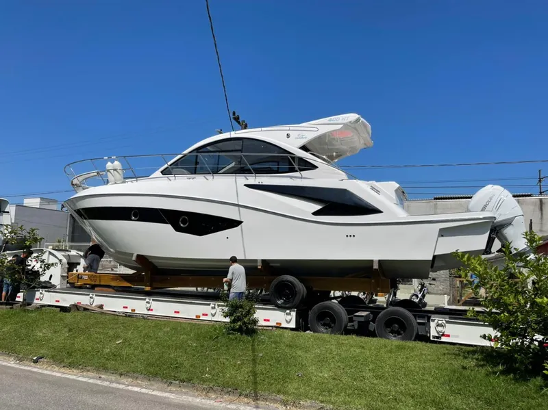 Slide: The Image of 2021 Evolve 400HT yacht on trailer under clear blue sky. - 2
